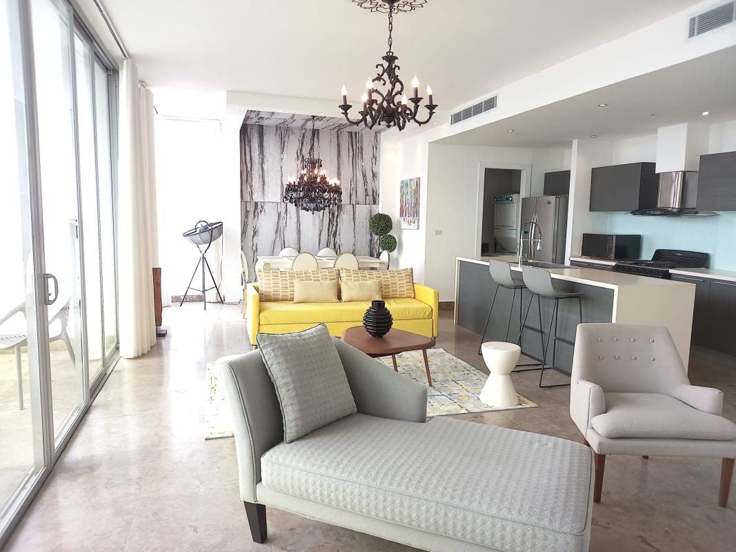 Spacious living dining area modern kitchen island marble accents in Yoo Panama Avenida Balboa Panama