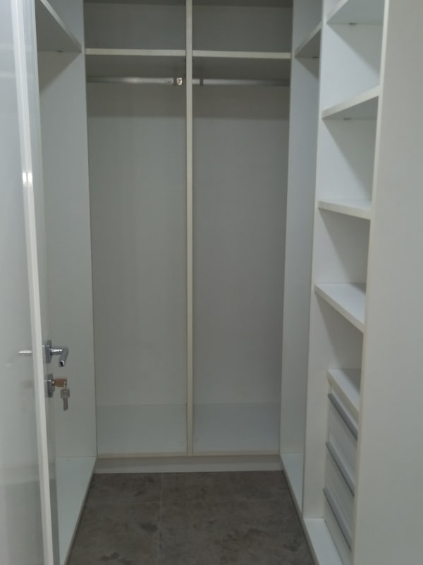 Spacious master bedroom with gray upholstered headboard ensuite marble bathroom in Yoo Panama apartment