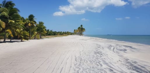 Sunset over calm ocean from beachfront lot in Buenaventura Resort Panama