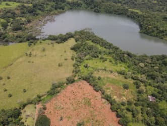 Aerial photo with lake, open fields and wooded patches, ideal Panama countryside development land