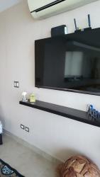 Contemporary kitchen with granite counters, bar stools oceanfront condo Santa Clara