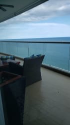 Spacious living area with large windows, balcony access, ocean view Santa Clara Beach Panama
