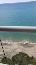 Modern bathroom with glass-enclosed shower and vanity at Santa Clara Residences beach condo