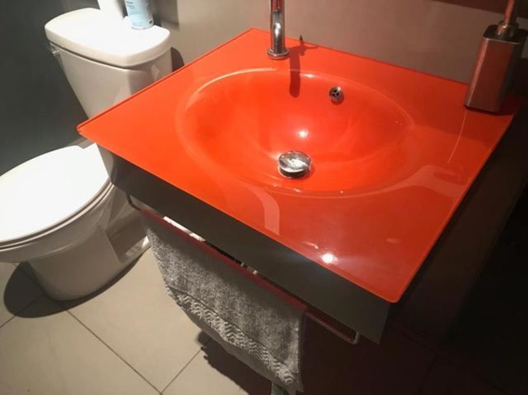 Office bathroom with bold accent sink and modern design Plaza Empresarial Panama