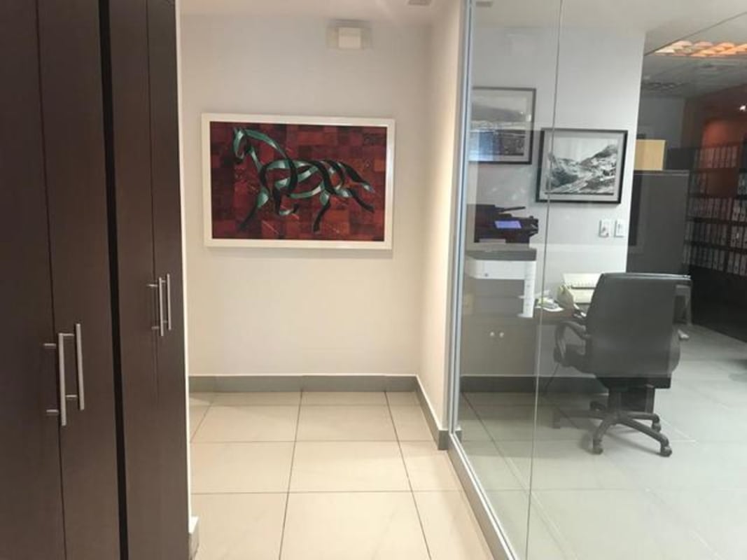 Private enclosed office with glass wall and wood cabinetry in Plaza Empresarial Panama