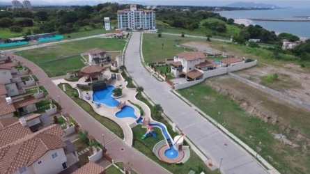 Drone view coastal condos, pools, gardens, oceanfront PH Coral Fontanella San Carlos Panama