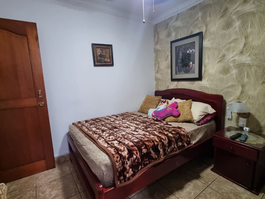 Bedroom with closet, ceramic tile floor, and window in PH Carrasquilla Panama