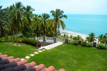 Outdoor terrace with ocean view seating and sunshade overlooking Pacific beach Río Hato Panama