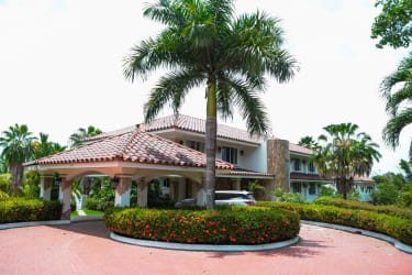 Front facade of two-level Mediterranean villa with lush garden in Río Hato Panama