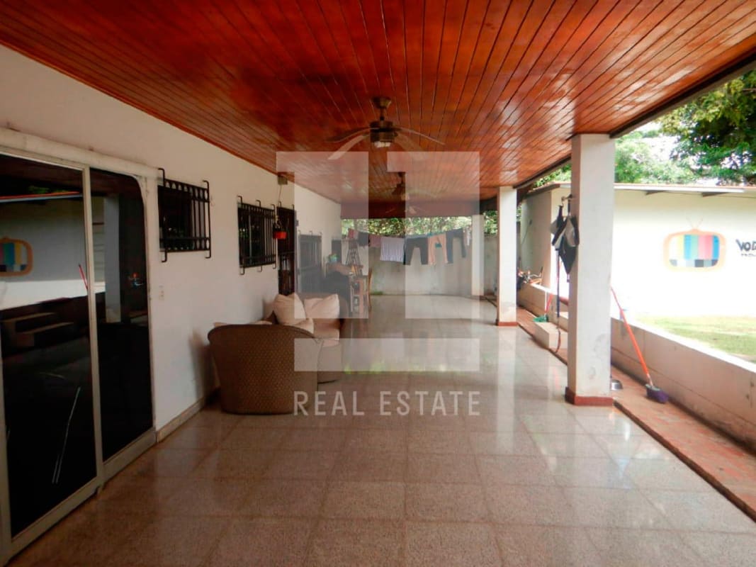 Covered terrace with ceiling fans, garden view in a commercial corner lot Coco del Mar Panama