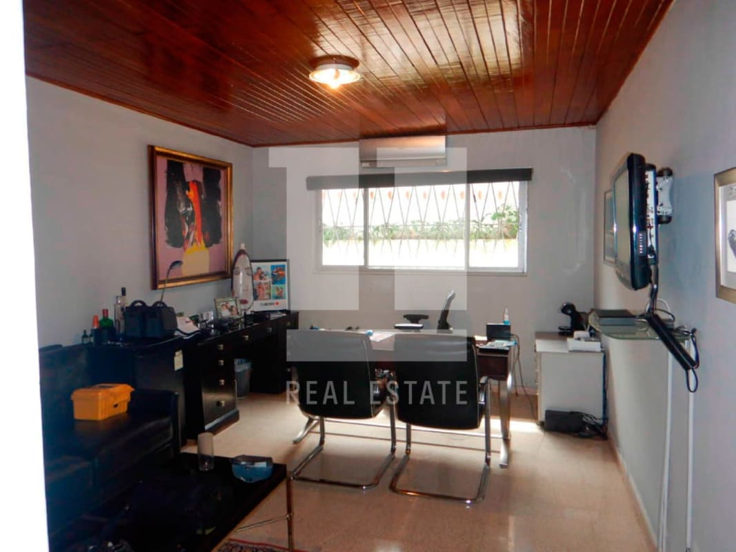 Kitchen with granite counters, white cabinets, cafeteria space in commercial property Coco del Mar Panama