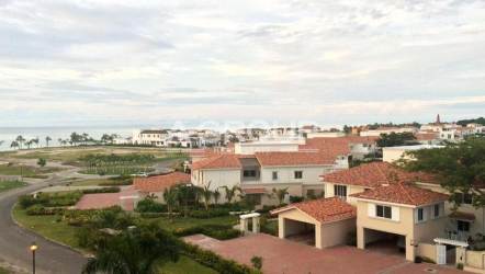 Bedroom with balcony access, modern lighting and ocean views in luxury beach condo Panama