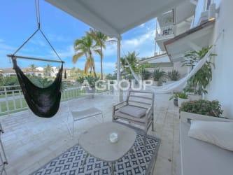 Covered balcony with hammock and seating overlooking tropical gardens in Puntarena Buenaventura Panama