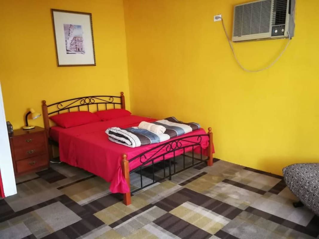 Bright air conditioned bedroom with colorful decor and window Buenaventura Panama