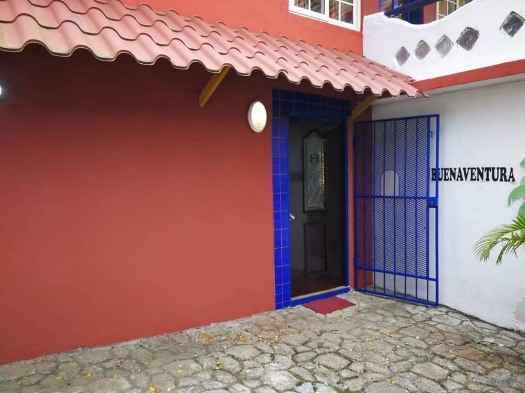 Mediterranean style entry with blue gate, tiled roof, in Buenaventura Panama rental