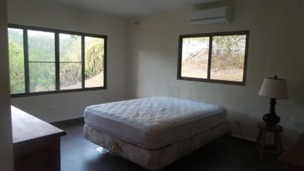 Spacious living room with vaulted ceiling, fans, and large windows at Altos del María house