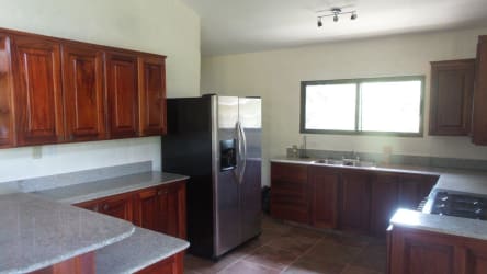 Covered outdoor terrace with tile floors overlooking forest and mountains