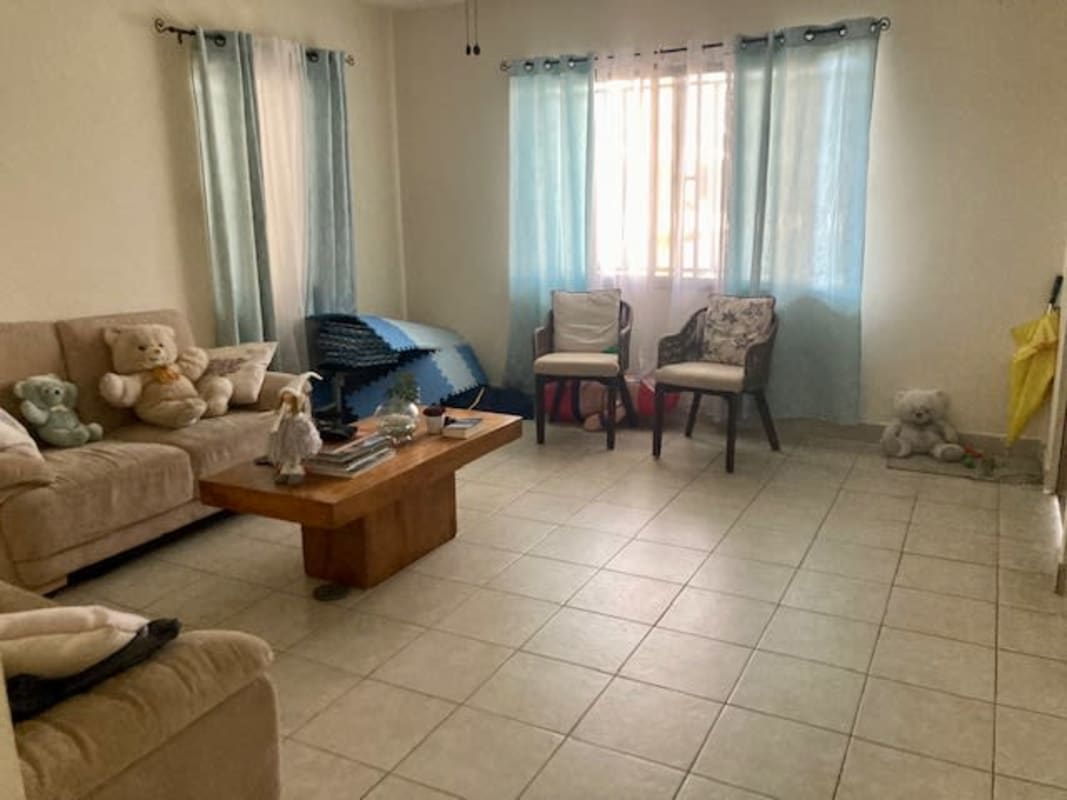 Sunny living room with tile flooring large window in Betania house Panama City