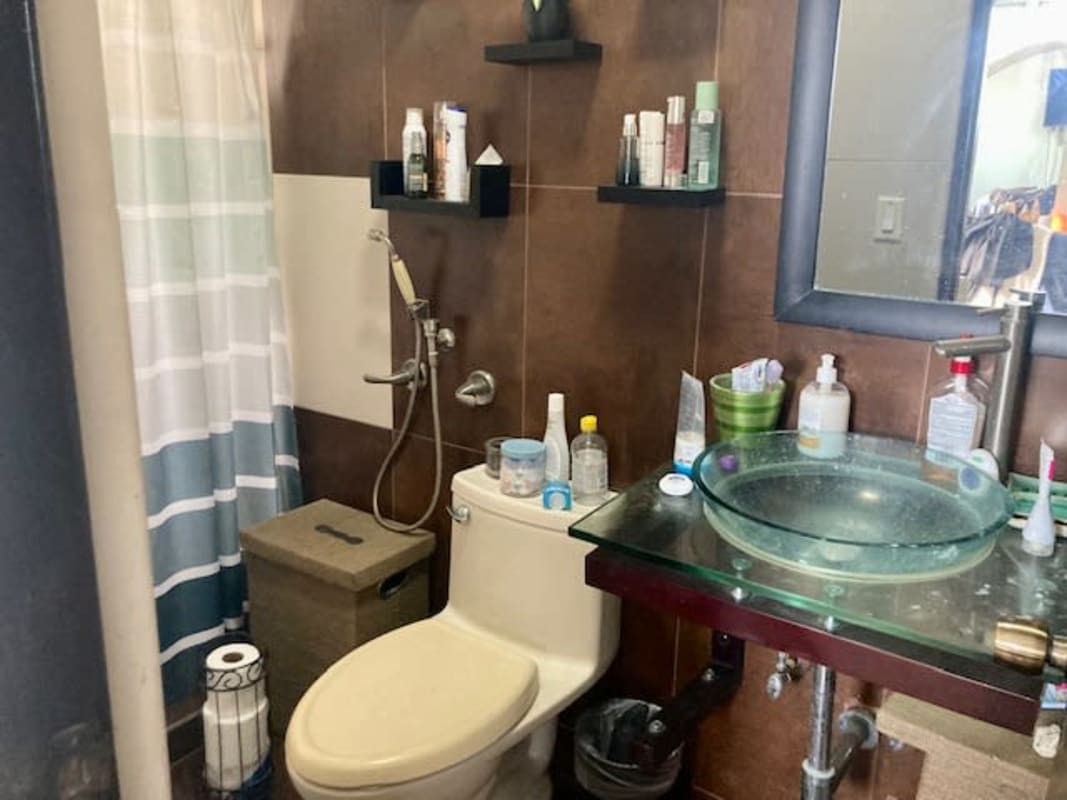 Bathroom with vessel sink tiled walls walk-in shower Betania house Panama City