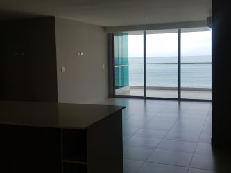 Modern living room with floor-to-ceiling windows ocean view Lighthouse Tower Playa Blanca Panama