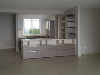 Modern minimalist kitchen with island and open shelves in Lighthouse Tower Playa Blanca Panama