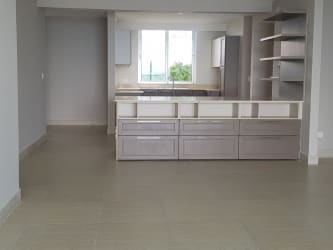 Modern minimalist kitchen dining with island and open shelf Lighthouse Tower Playa Blanca Panama