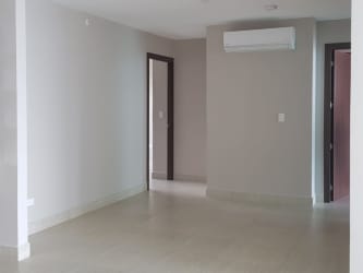 Empty living room with tile floor and AC unit in Lighthouse Tower Playa Blanca Panama