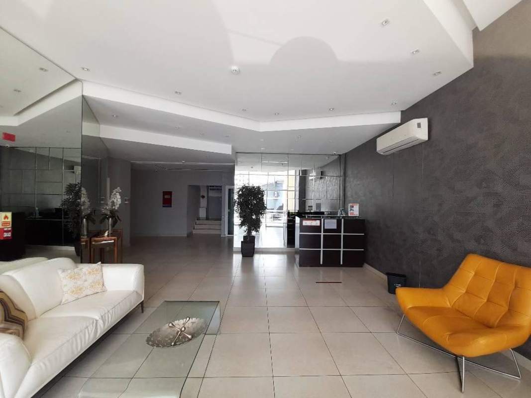 Lobby with sofas, mirrors and reception area inside Taurus Tower Carrasquilla Panama City