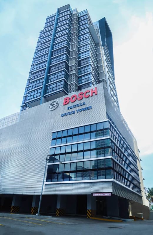Exterior view of modern high-rise commercial office tower with glass facade in Punta Paitilla Panama
