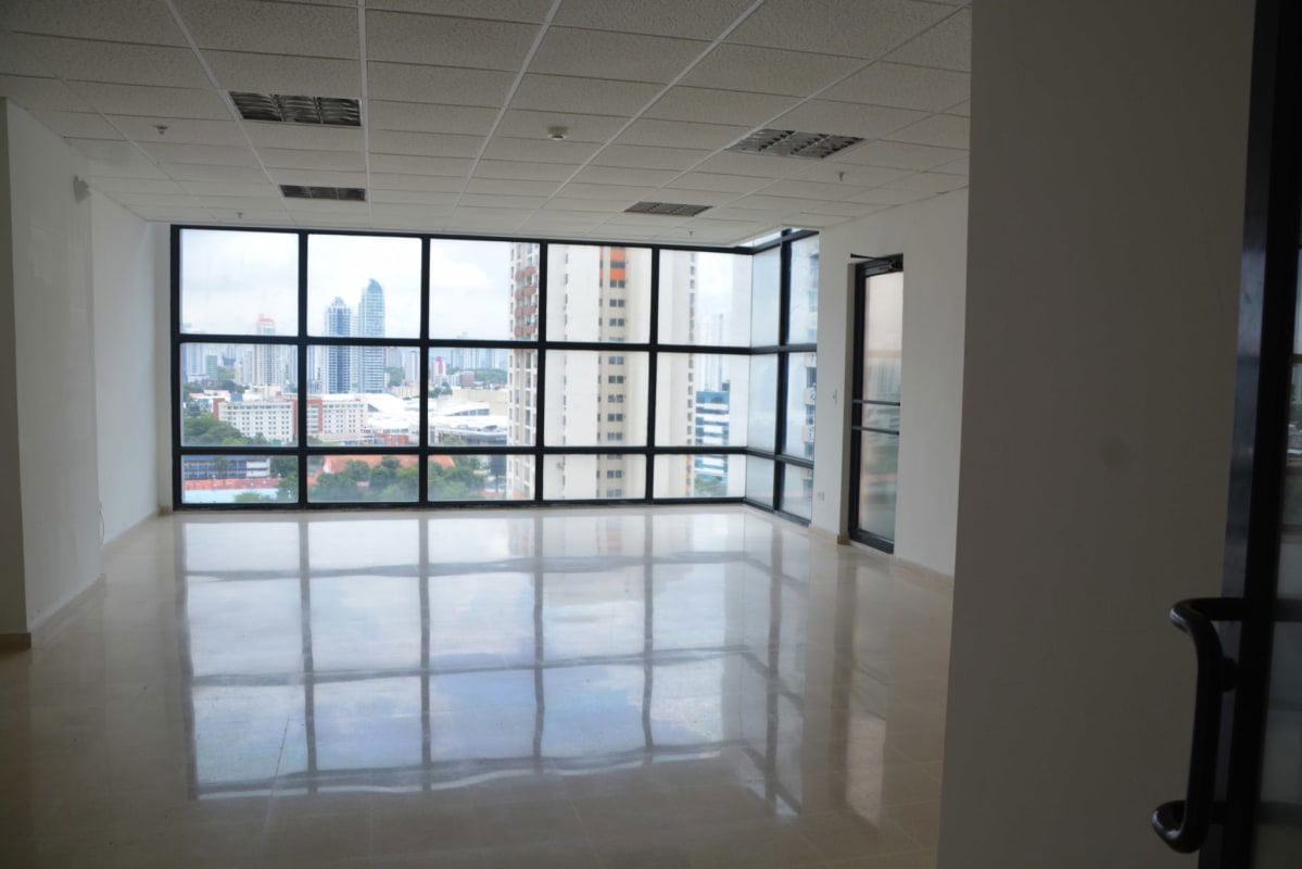 Bright modern corner office with floor-to-ceiling windows overlooking Panama skyline