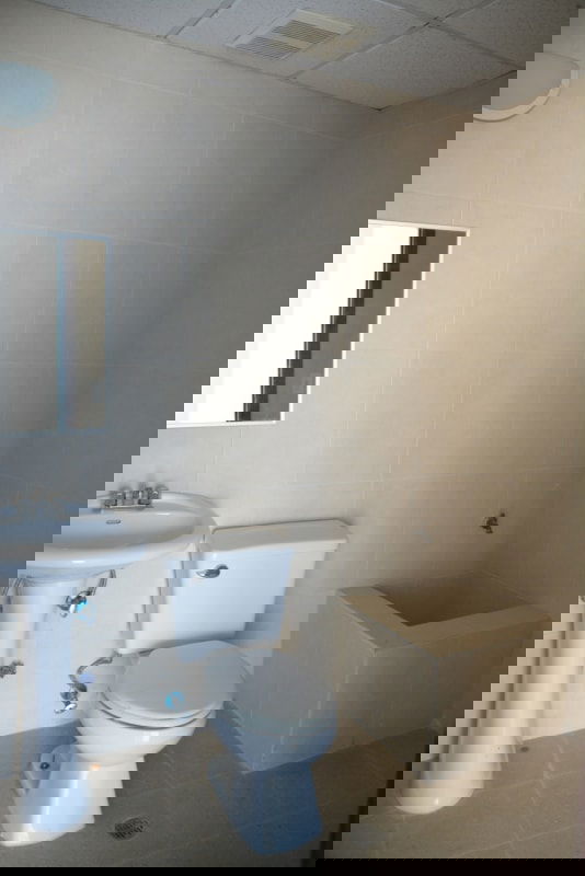 Commercial office lobby with black sofas, elevators, reception area at Paitilla Office Tower Panama