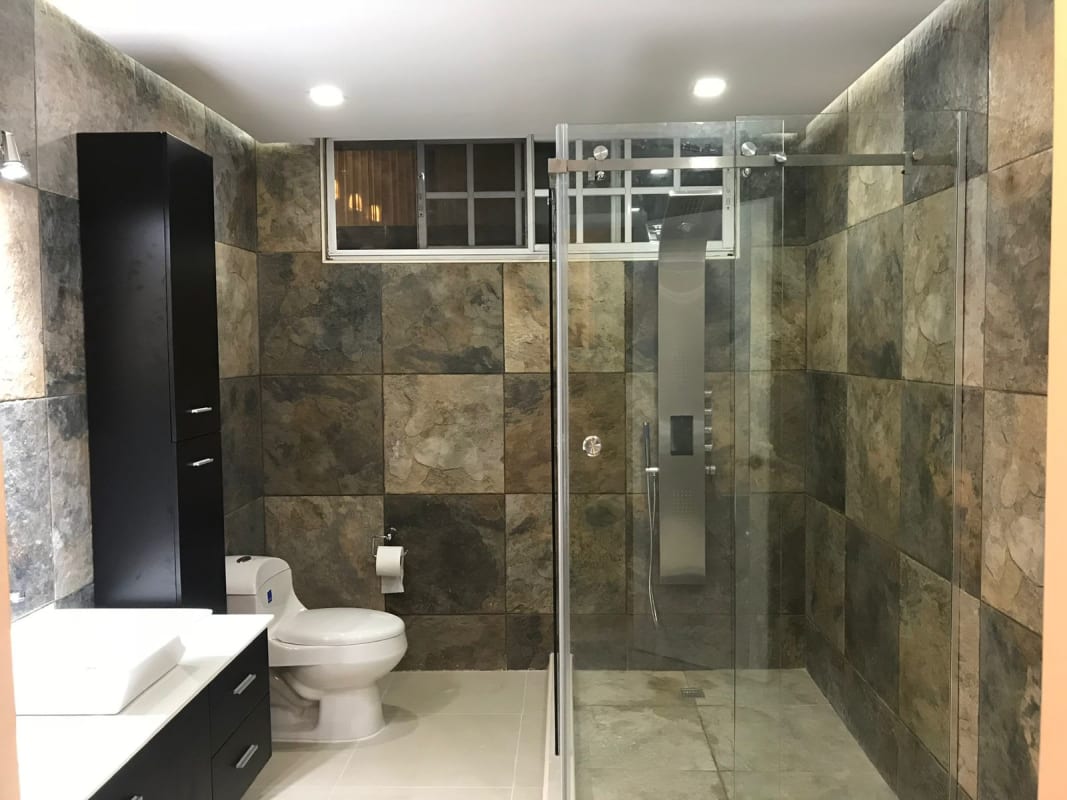 Modern bathroom with vessel sink, rainfall shower and stone mosaic in PH El Carmen Vista Hermosa