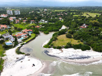 Beachfront residential community with ocean and river mouth view