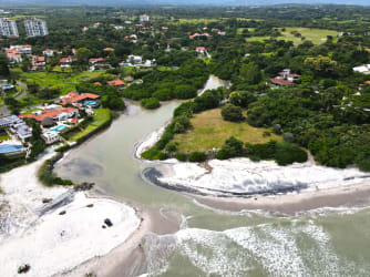 Beachfront community aerial view with ocean shore at Punta Barco Panama