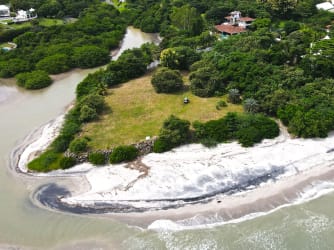 Aerial of private beachfront with lush greenery and ocean access in Panama