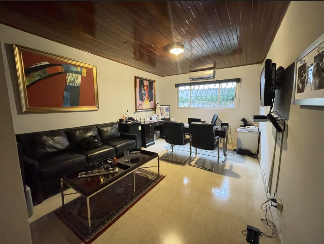 Modern home office with black furniture, wall art, large window at Coco Corporate Center Panama City