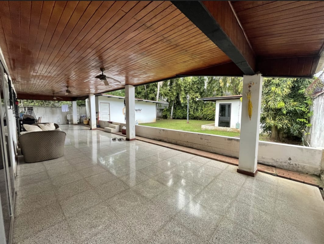 Modern reception lobby with black leather seating and orange accent wall in Panama City
