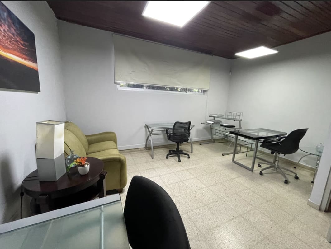 Modern home office with glass desk, minimalist decor, large window in Coco del Mar Panama