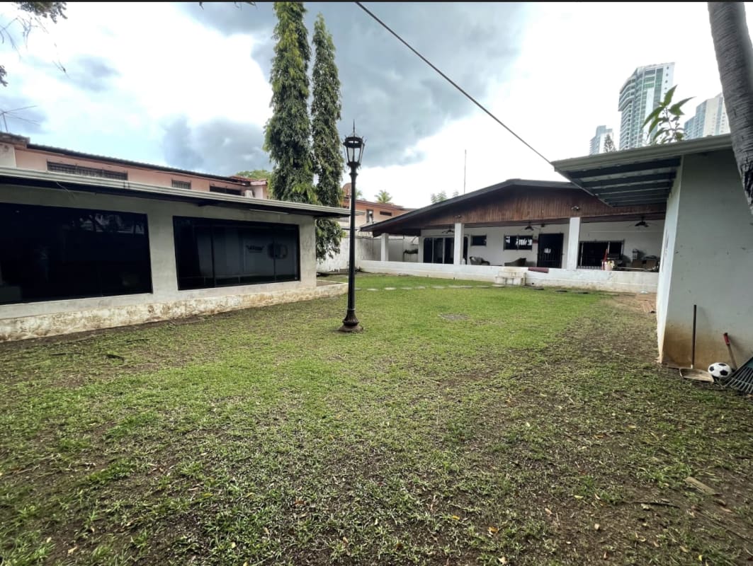 Modern conference meeting room with glass table, wooden chairs, and bright window in commercial office Panama City