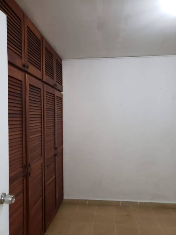 Simple minimalist kitchen with white tiled walls and open shelving Villa Lucre Panama