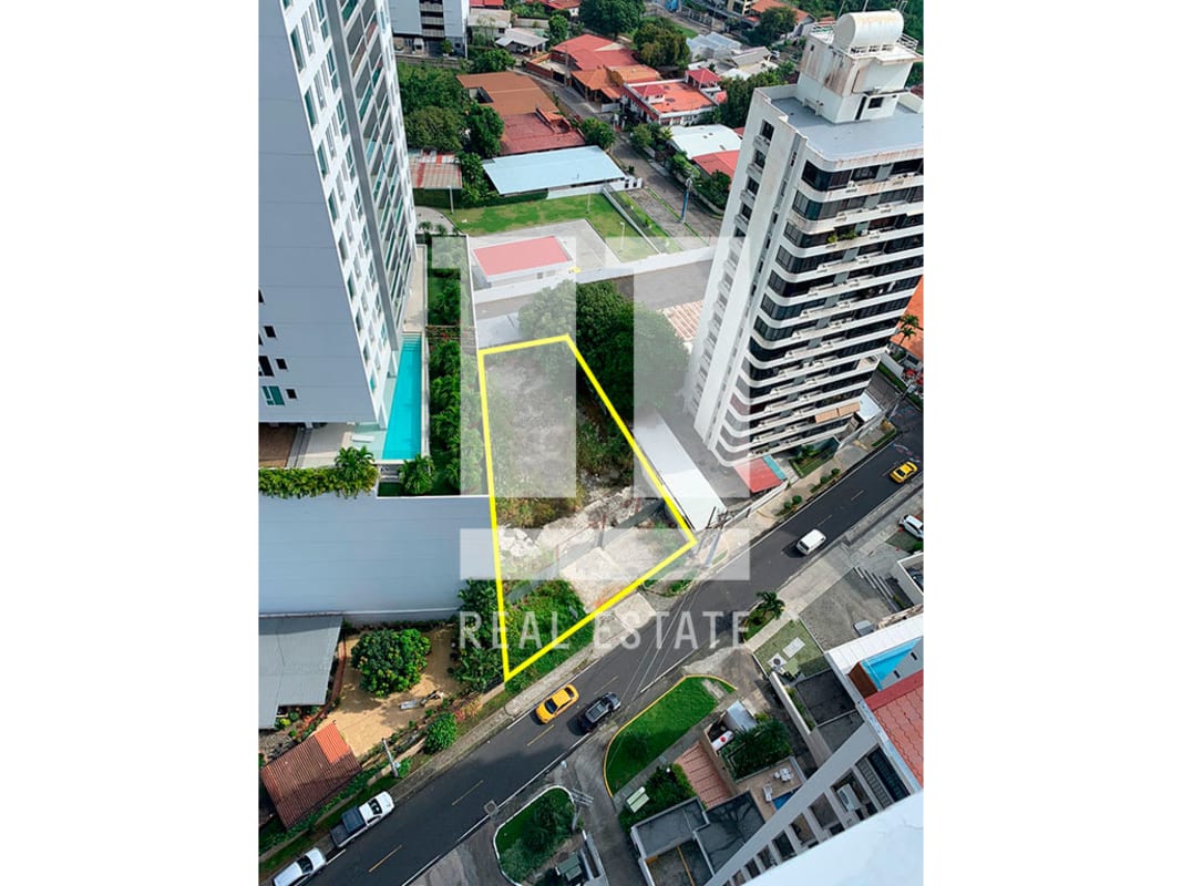 Aerial showing development lot surrounded by modern high-rise buildings and pool in Coco del Mar Panama