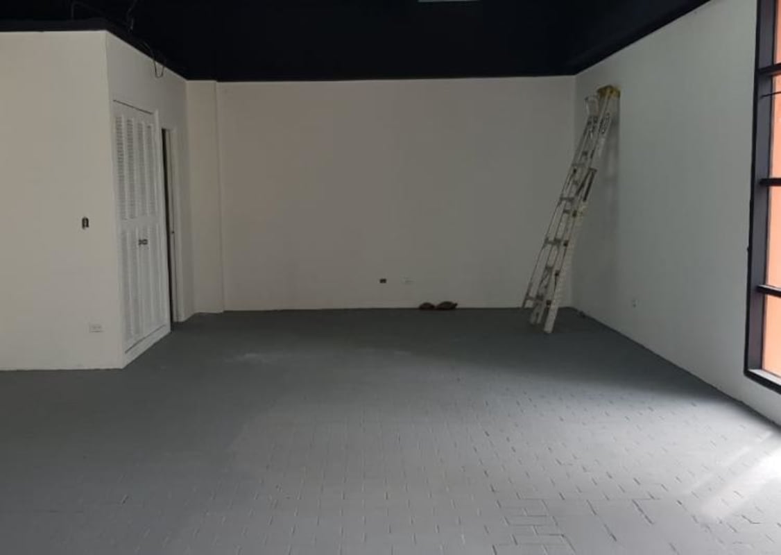 Office or retail space inside Via Veneto Plaza with large window and gray floors in Panama City