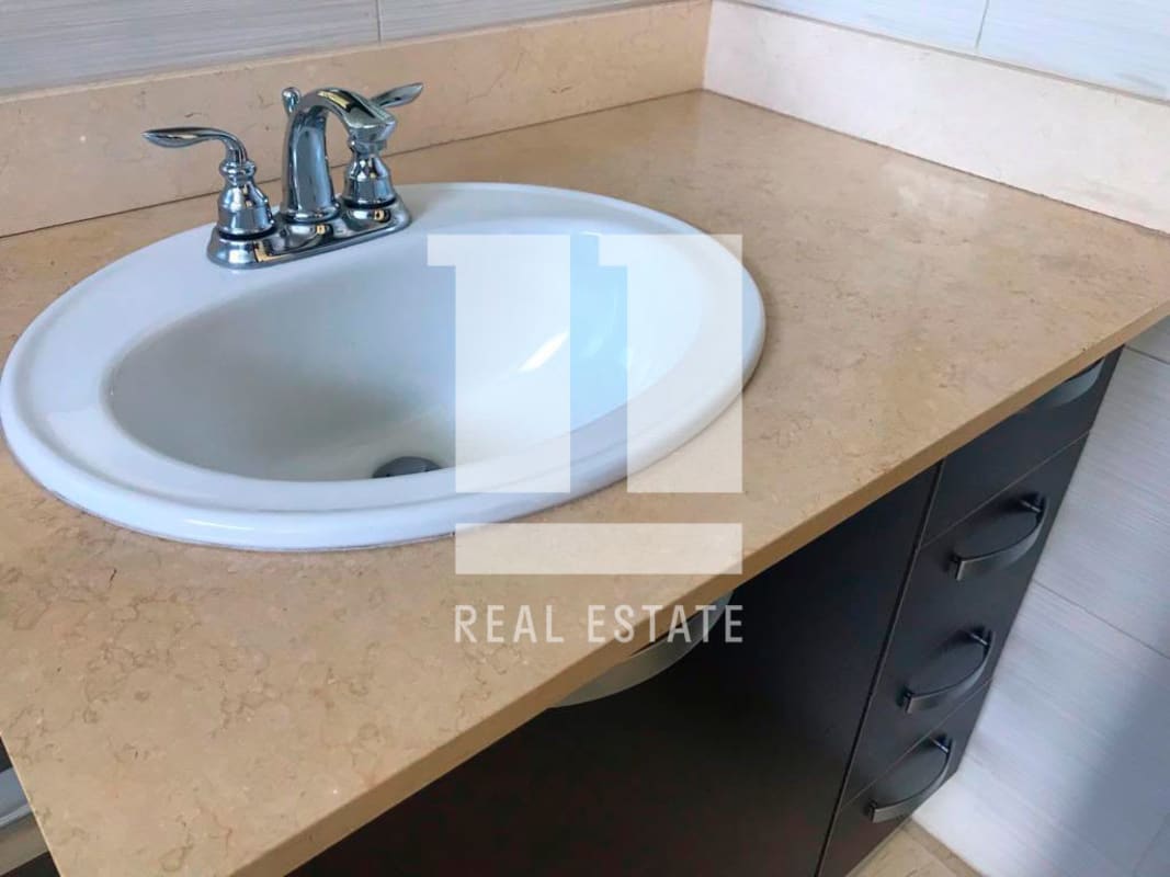 Modern bathroom with marble counters, double sink vanity and large mirror in PH Puntarenas Coco del Mar Panama