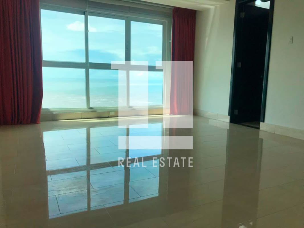 Bright living room in penthouse with floor-to-ceiling windows offering ocean views at PH Puntarenas Coco del Mar Panama