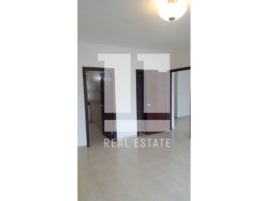 Open-plan living area with porcelain tile, minimalist kitchen and ocean views in Granbay Tower Marbella