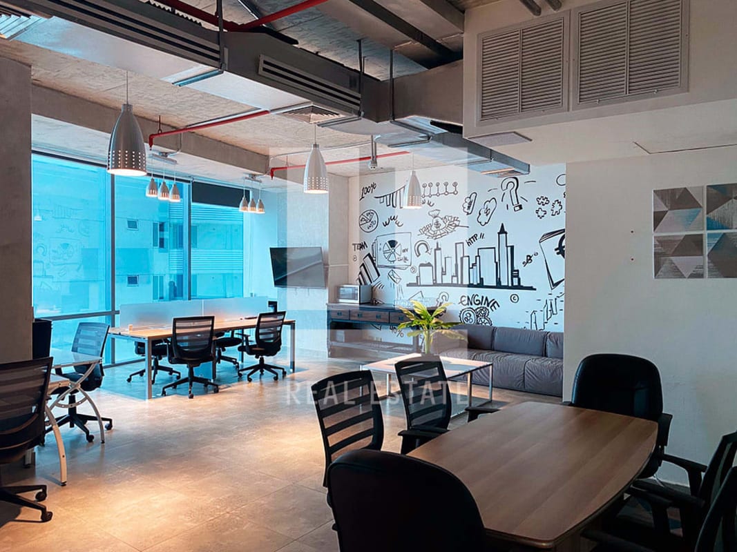 Industrial style office with mural wall, meeting area, large windows at PH Financial Park Costa del Este Panama City