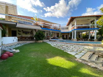 Spacious living room with exposed beams, coastal decor, Punta Barco Resort luxury villa Panama