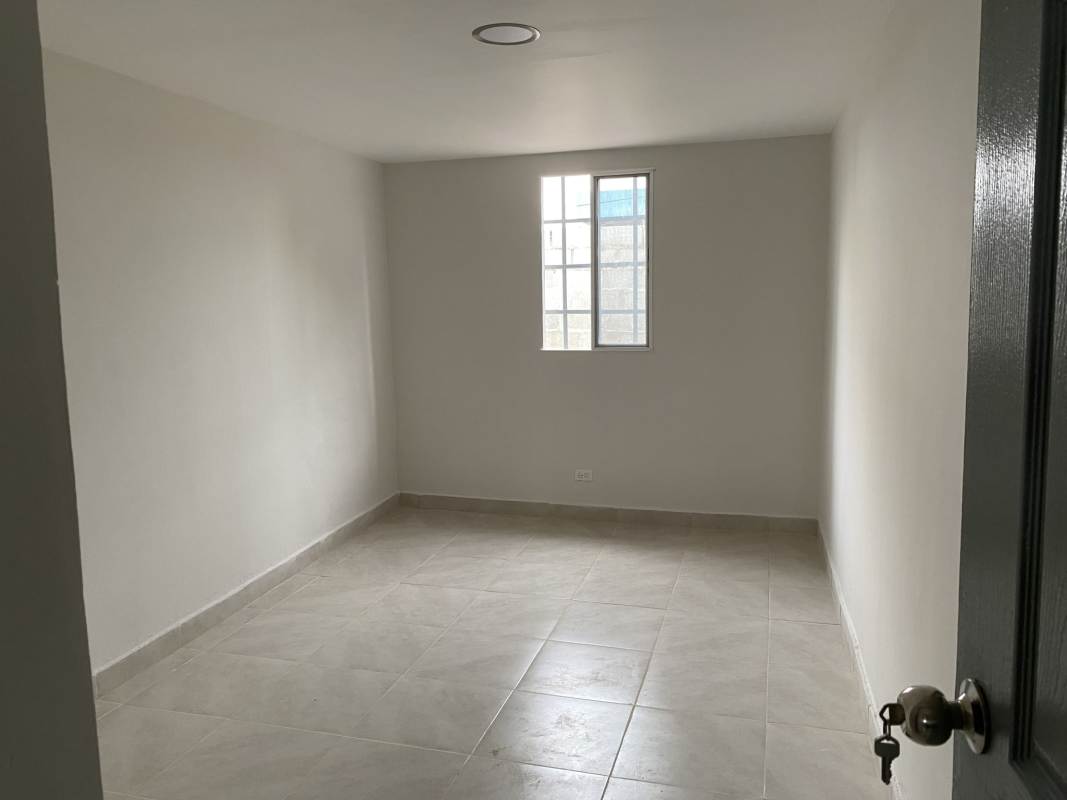 Empty bedroom with tiled floor and window with bars Altos de San Angel Panama for rent