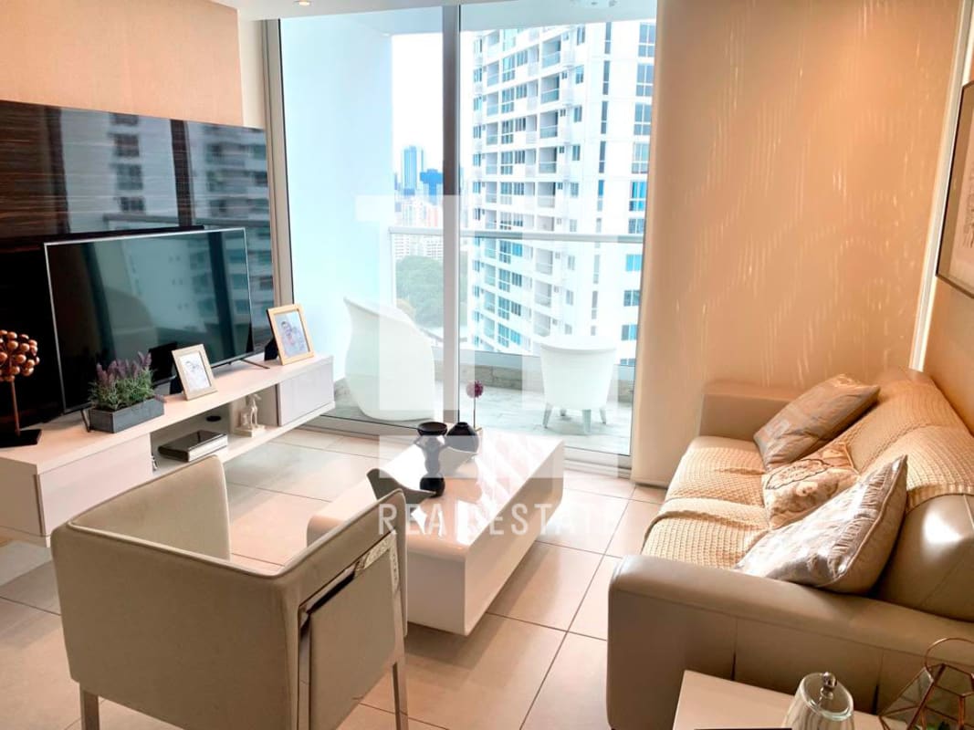 Living room with large sliding glass doors to balcony city views PH Vivendi Green Panama