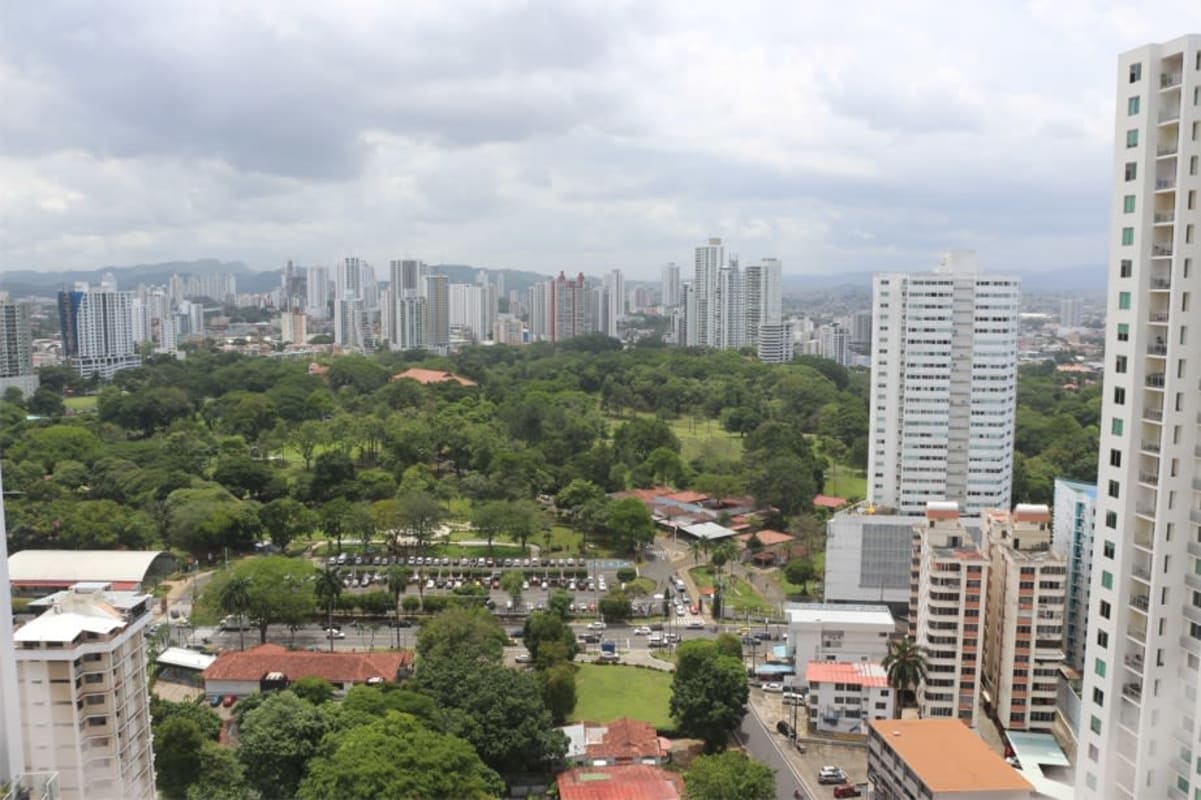 Modern bedroom with large window overlooking Panama City from PH The Regent